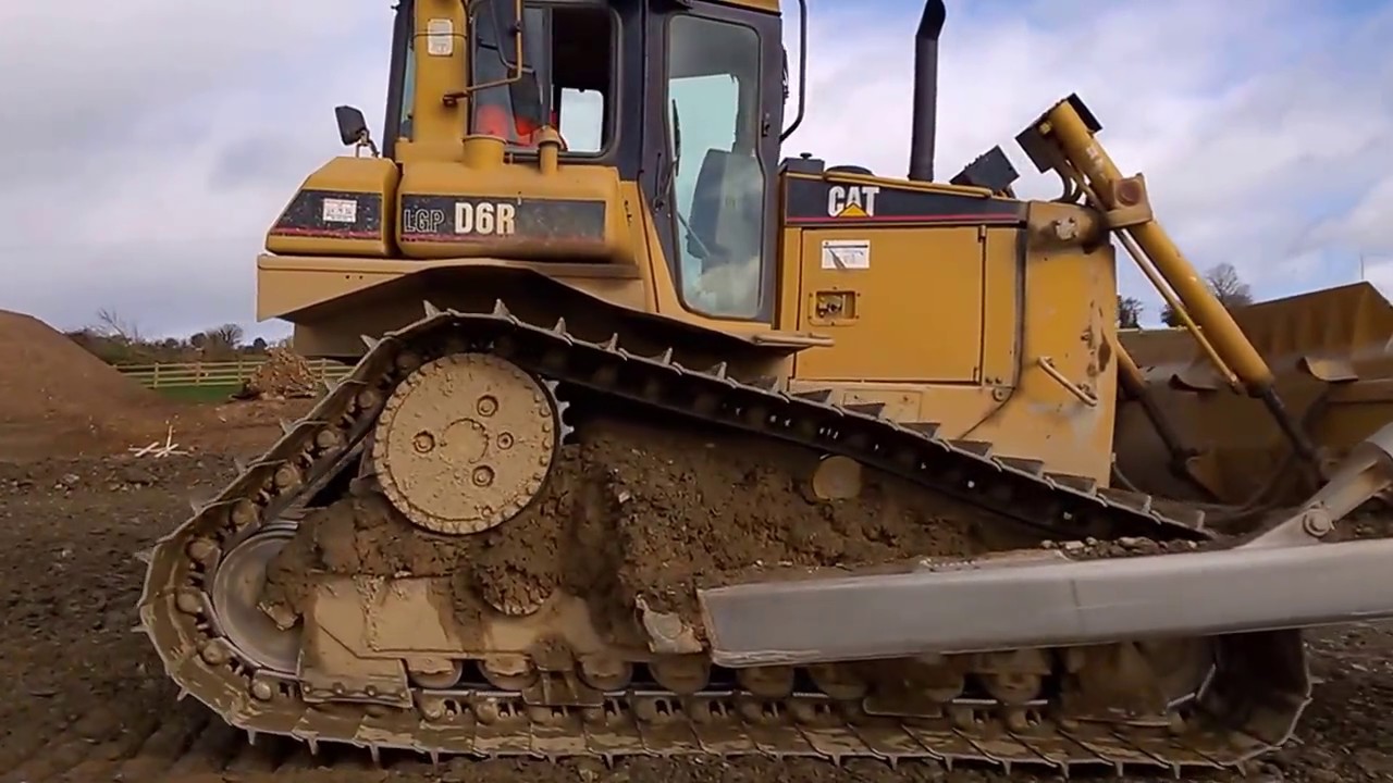 CAT D6 dozer at work levelling stone on a road construction site #2