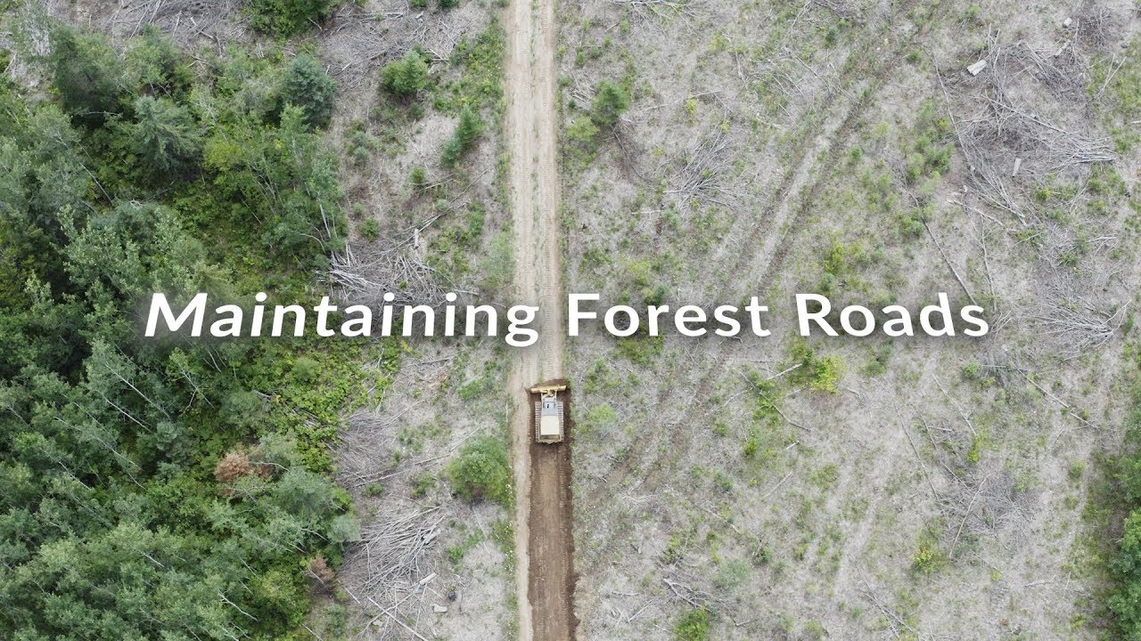 Installing water diversion bars and regrading forest logging roads
