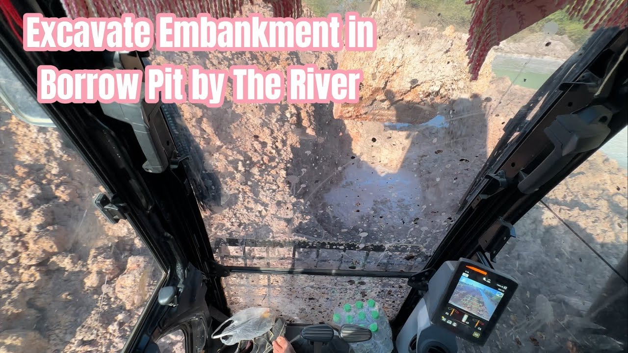 CAT 323 Excavator Digging by the River &ndash; Powerful Earthmoving Action