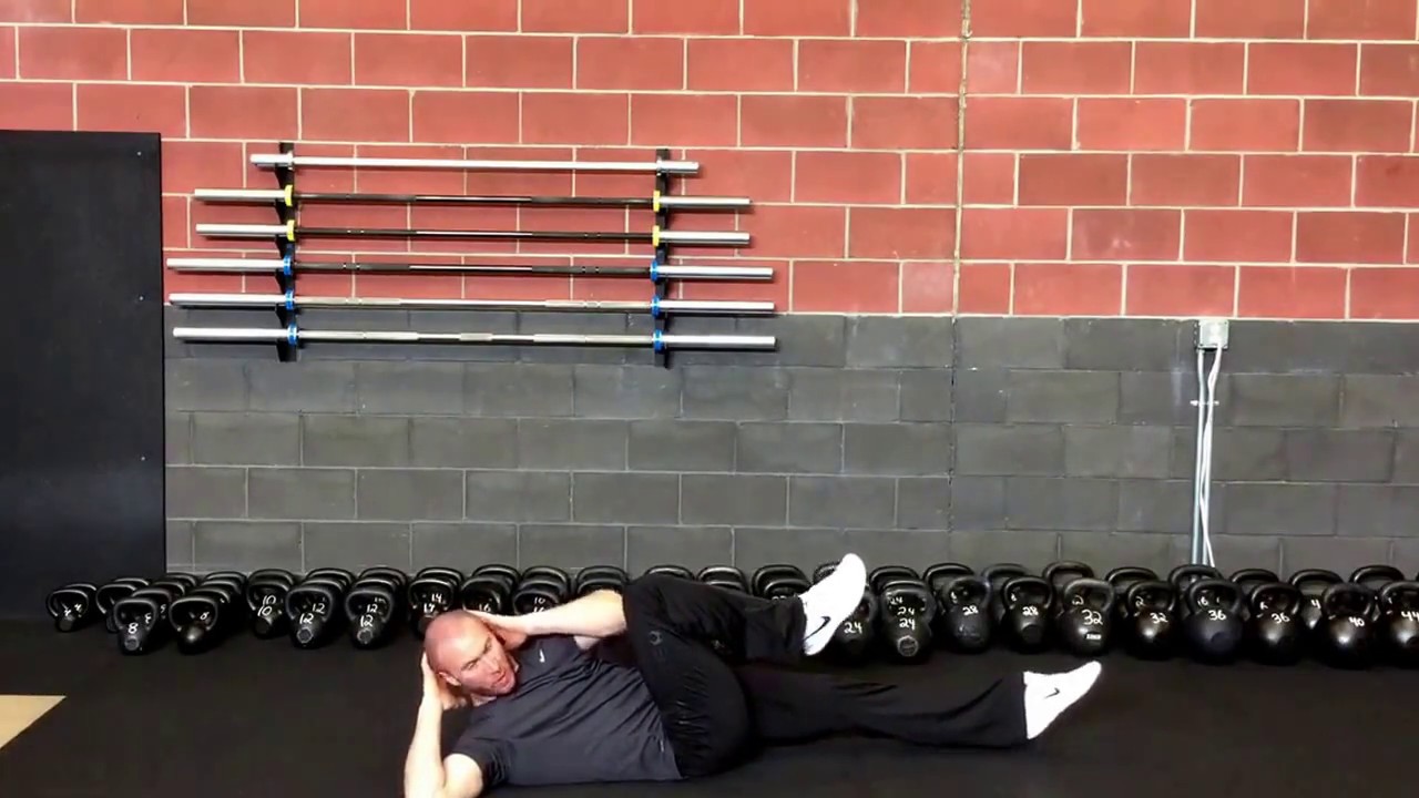 Minute Move Well Snack: Bicycle Cross Crawls | Empowered Strength ft. John Odden