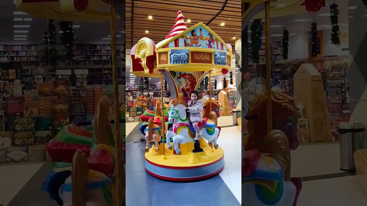 Horse carousel ride for babies and kids. Indoor game with horse carousel rise