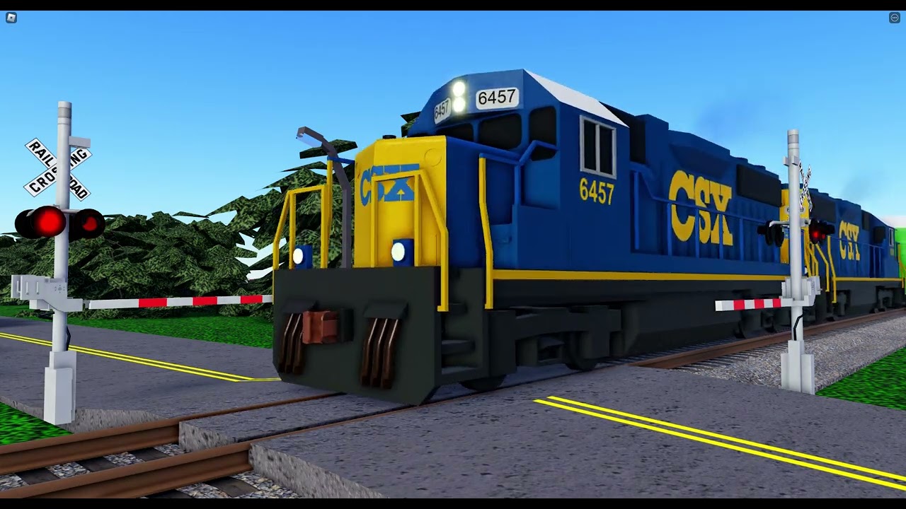 CSX GP40-2 6457 pulls its train up the 2.1% Grade and over E Benson Street with a longer train