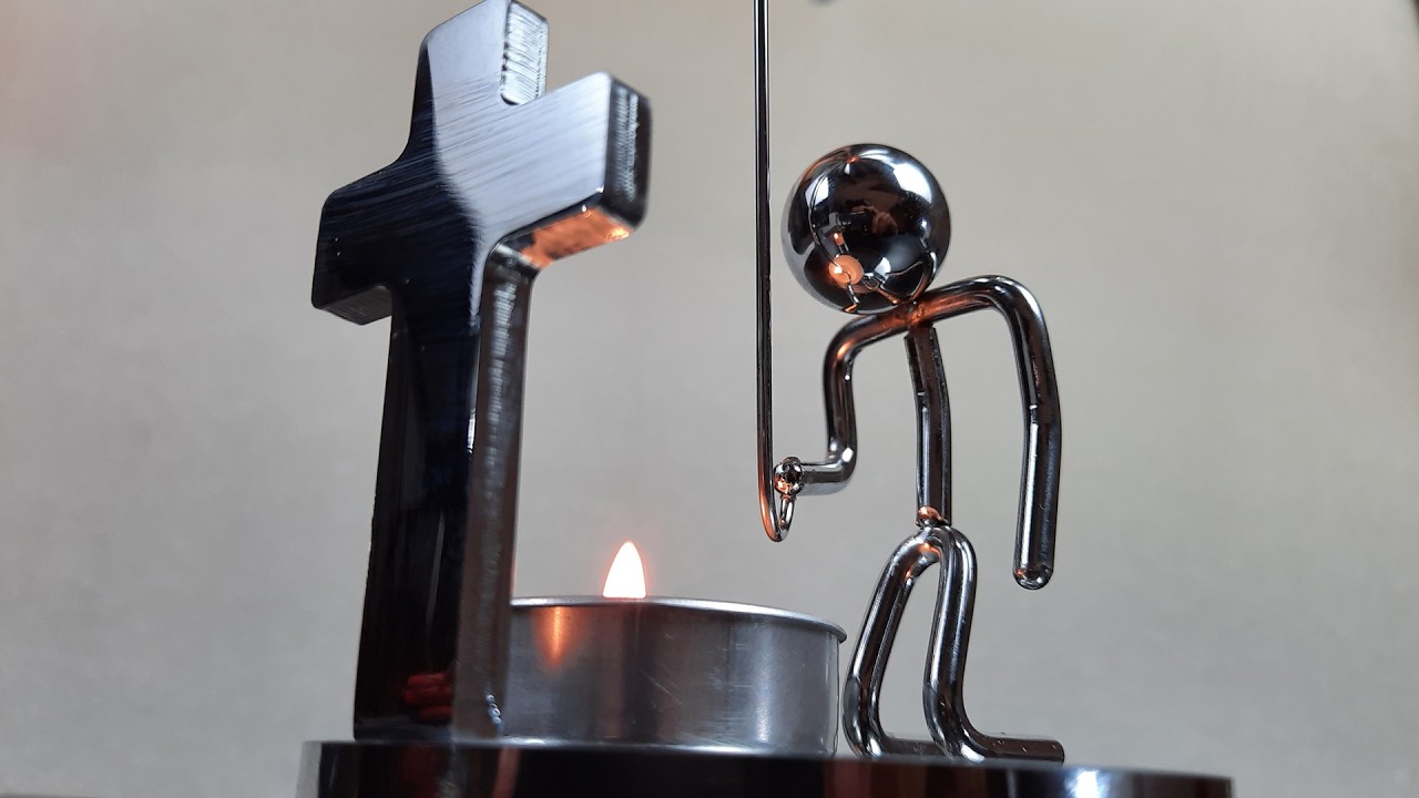 Sad Man Rotating Candle Holder: A Reflection on Sorrow and Faith