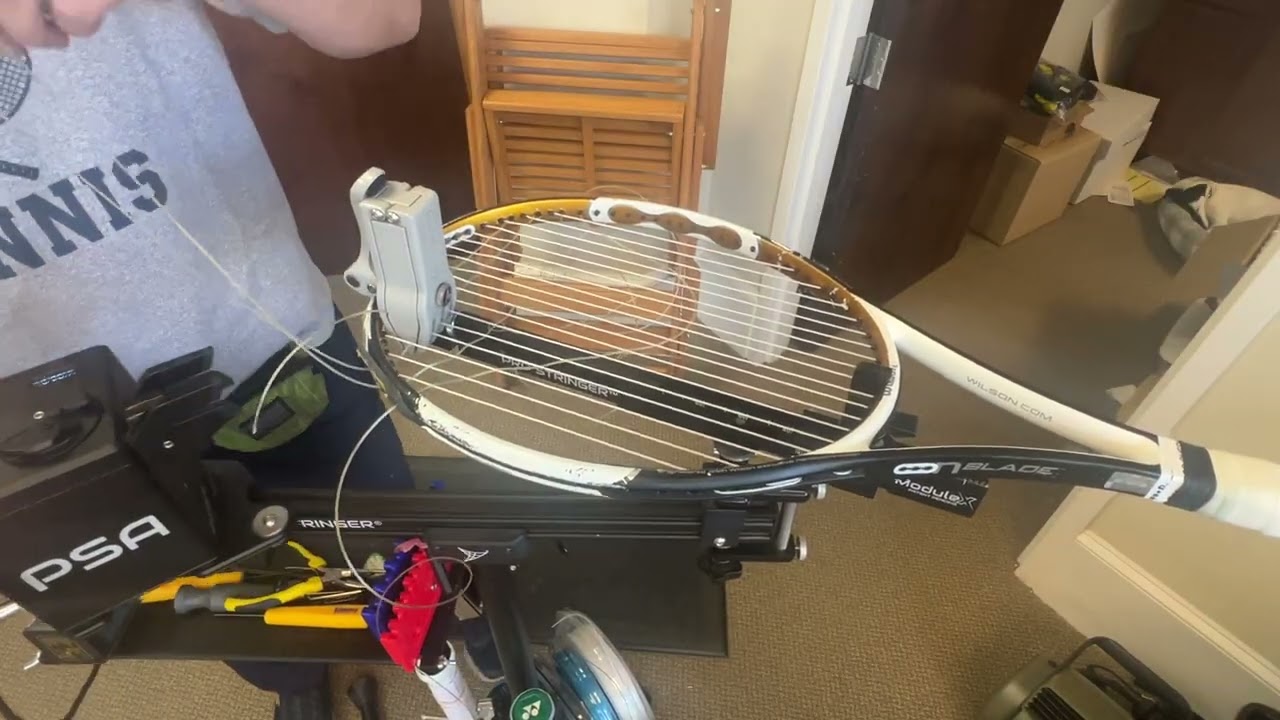 Carefully installing cross strings.  