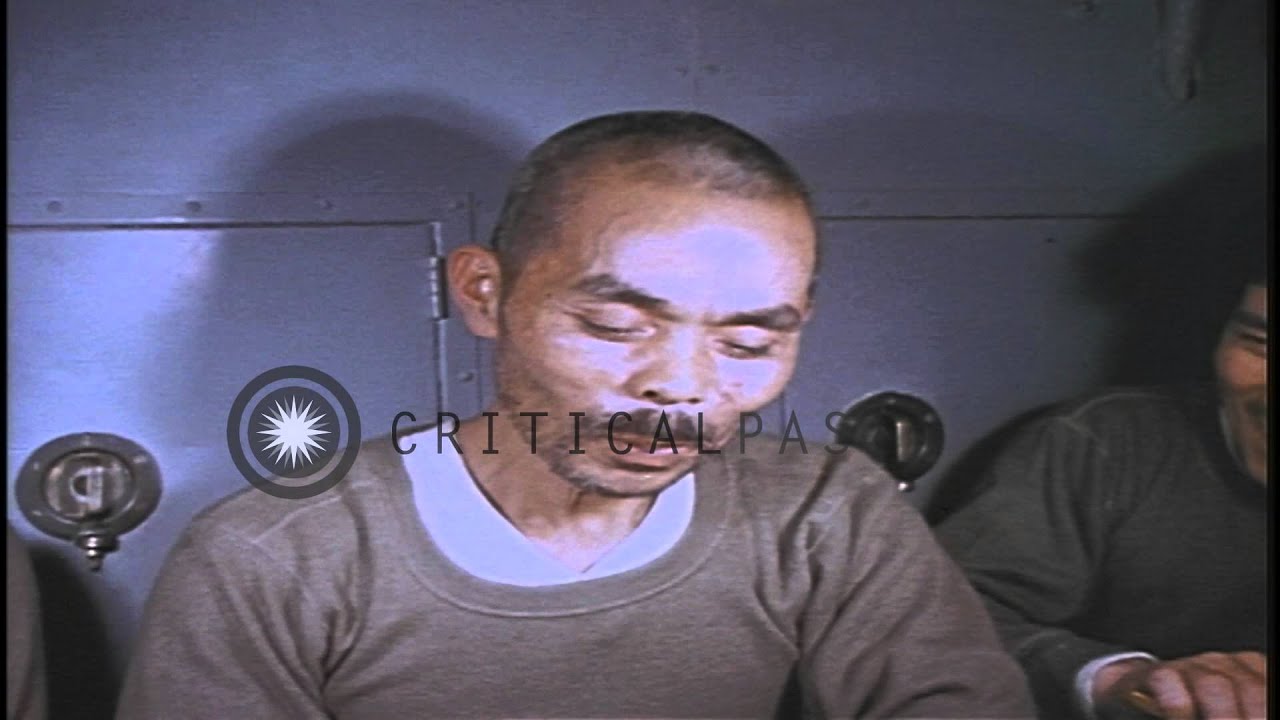 Japanese prisoners seated at a table eating food aboard USS Skate underway in the...HD Stock Footage