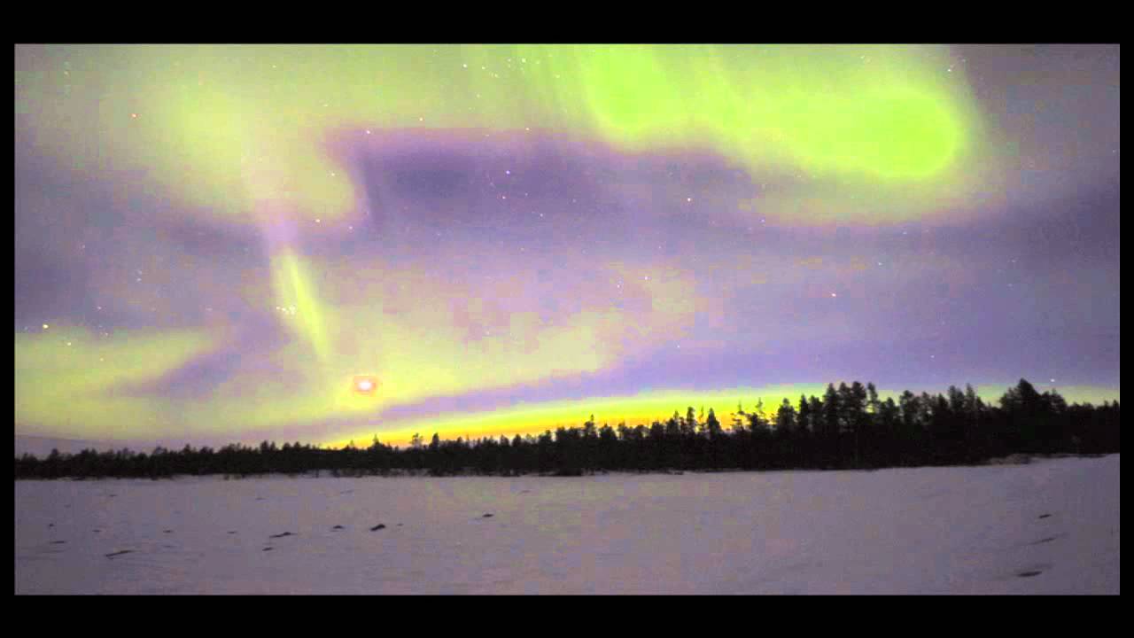 Northern Lights in real speed behind soft clouds in the moonlight.