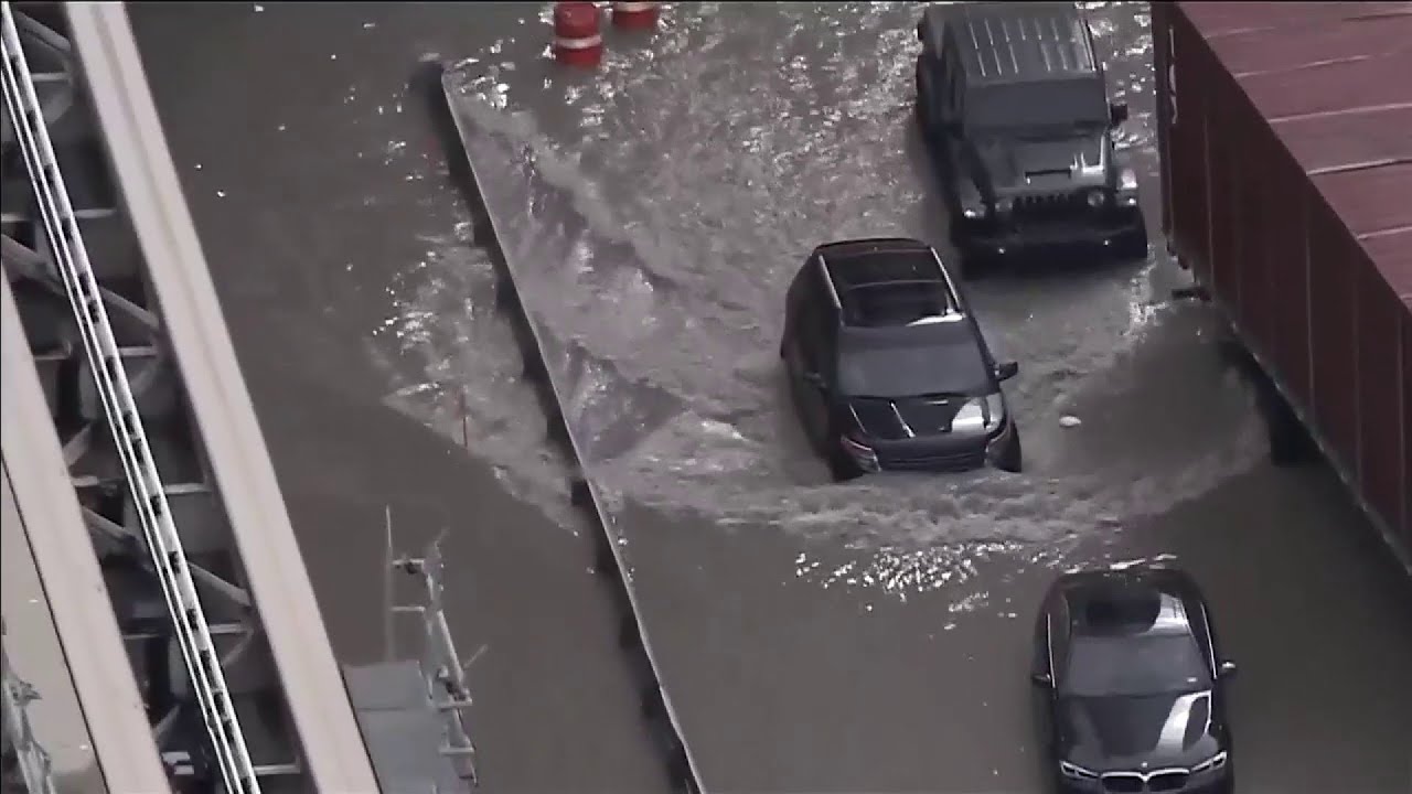 Vacuum trucks clear water after Miami streets flood in Downtown, Brickell