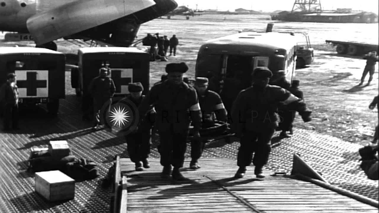 Soldiers load litter patients onto planes in Korea. HD Stock Footage