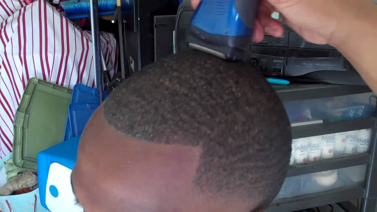 Caken' Cuts barber technique on waves with a bald taper