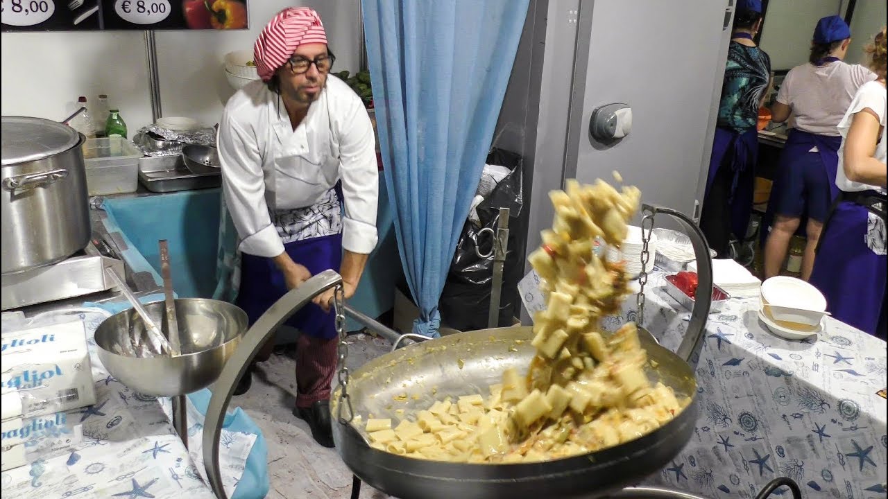Acrobatic Huge Pan with Italian Pasta 'Paccheri', Pepper and Codfish. Italian Street Food