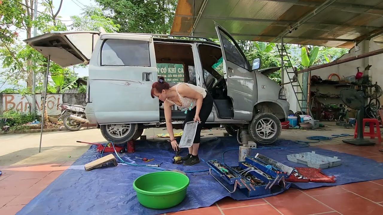 Genius girl repairs and maintains a broken old car.