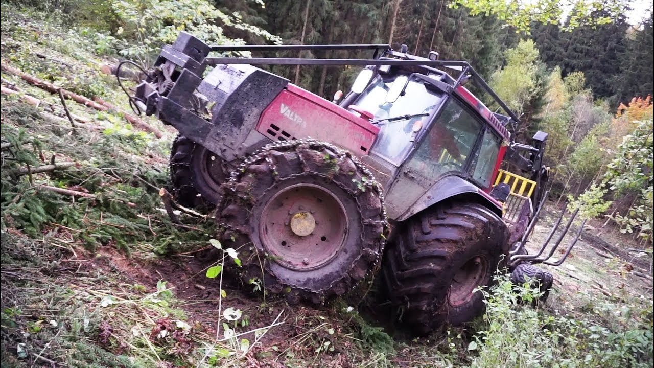 Valtra forestry tractor logging on steep slopes, slippery uphill, difficult conditions