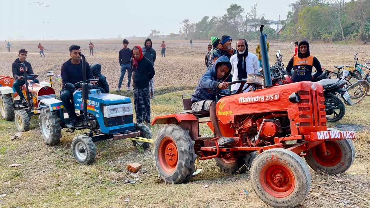Mahindra & Sonalika pull an Eicher tractor with a water tank out of the mud.