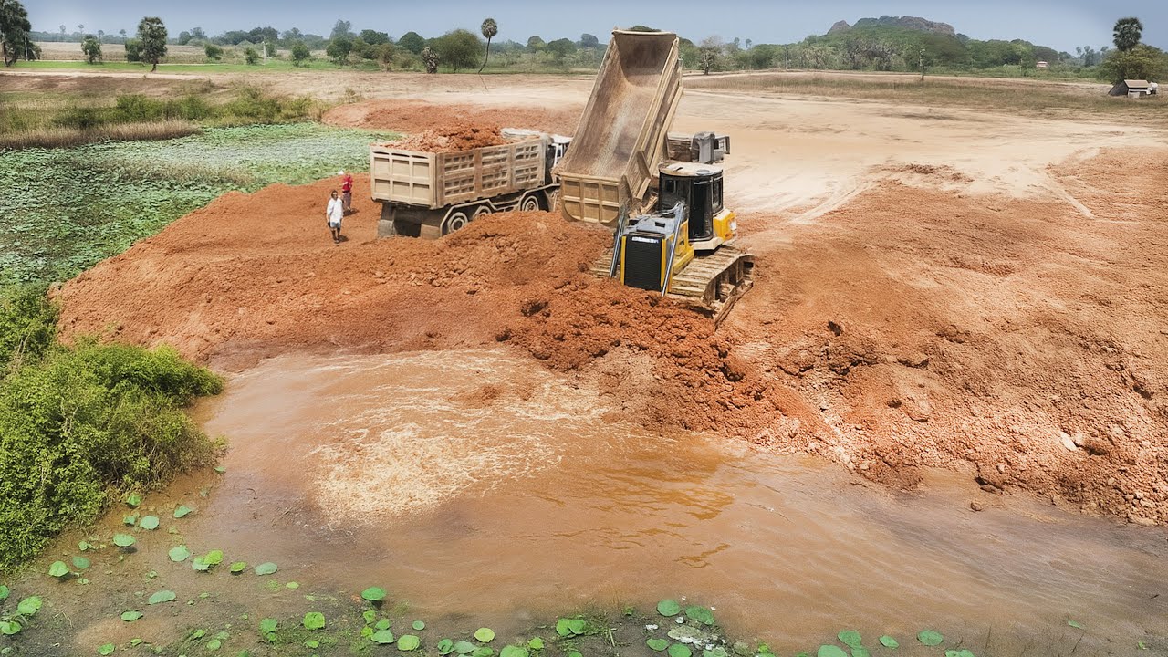 Rain or shine,  Both SHANTUI DH17 never stops working on Filling Big POND!