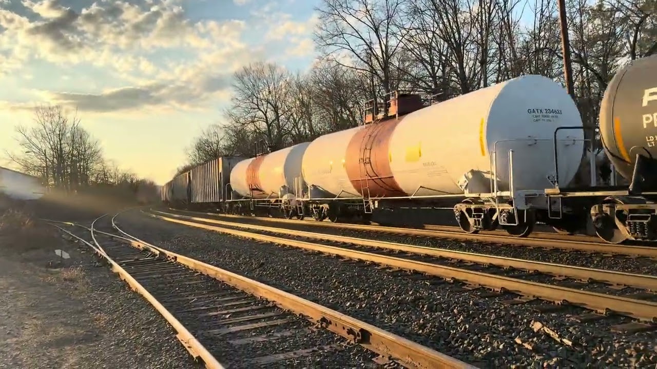 CSX 3128 ES44AH leads CSX M810 with a friendly crew at Piscataway with a sick K5HL