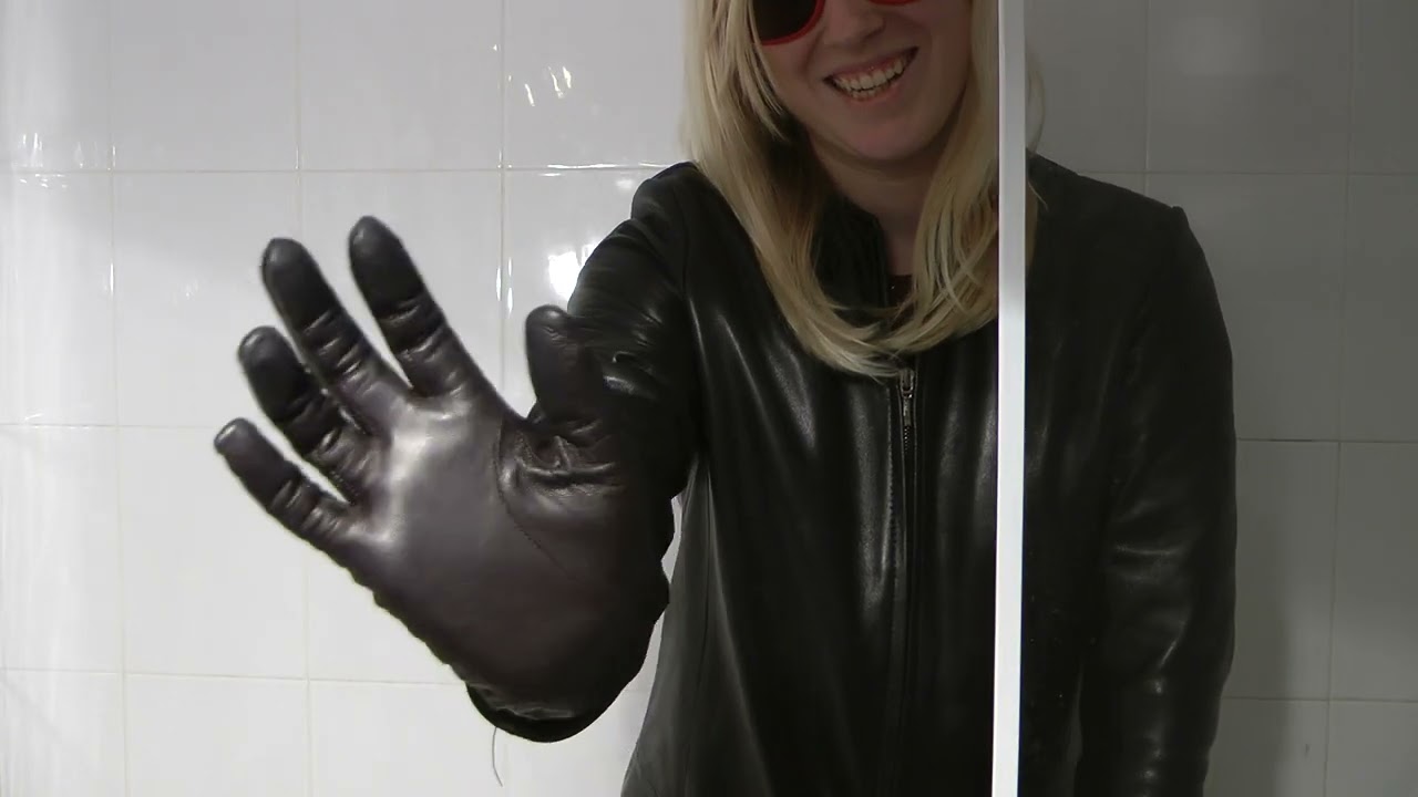 Emily girl in leather gloves with leather jacket and boots