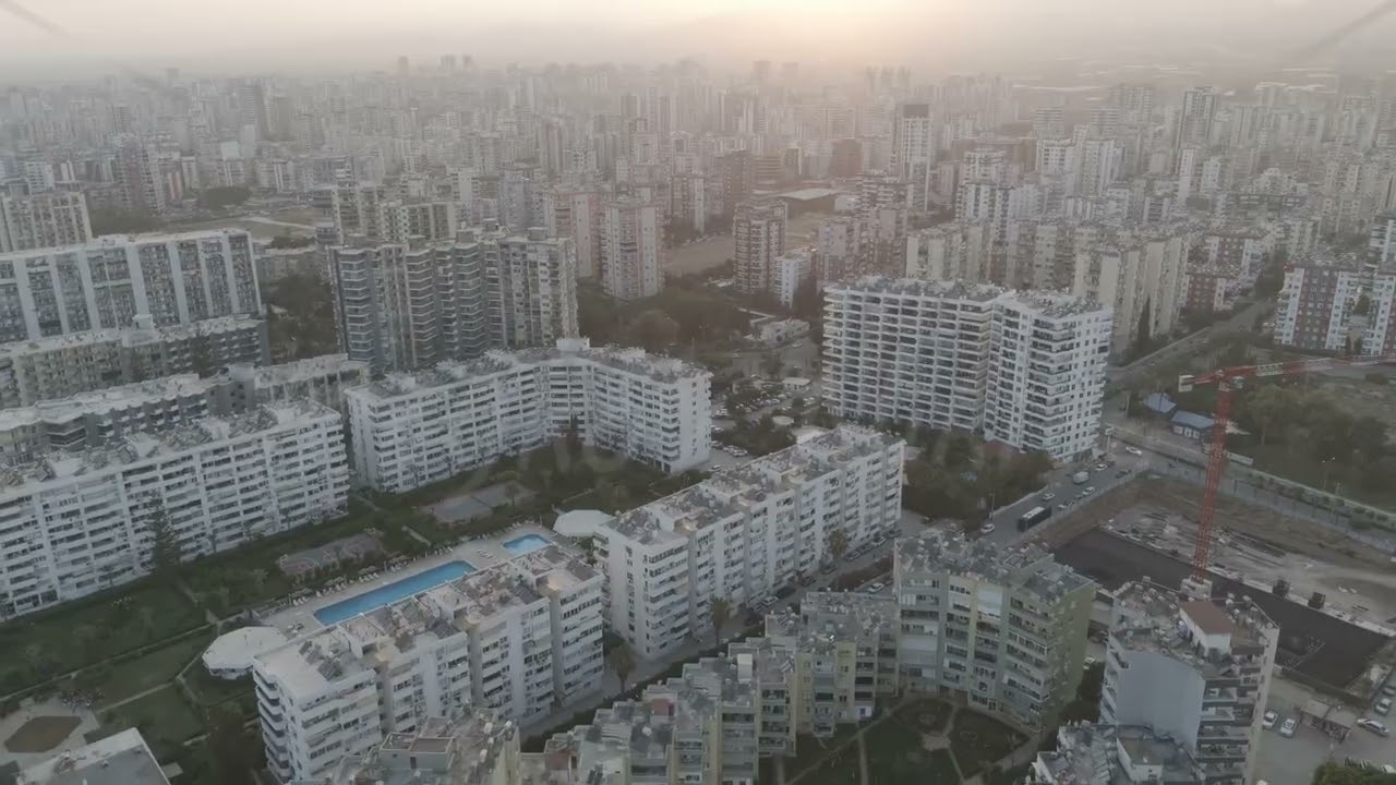 D-Log M. Mersin, Turkey. Drone view of residential apartment blocks fading into haze with backlig...