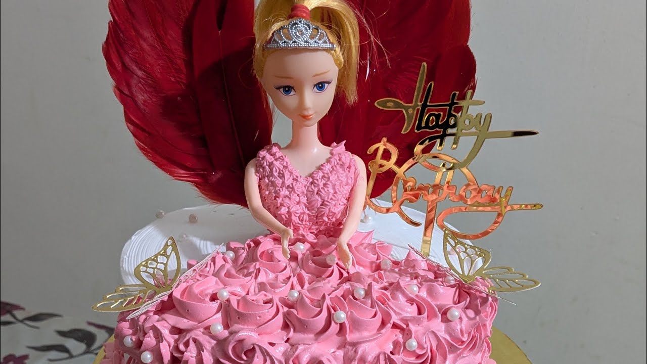 doll cake design in pineapple flavour icing with decoration