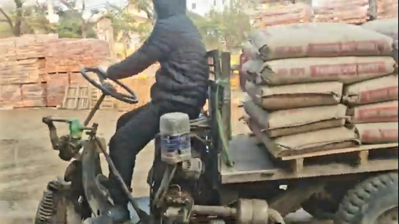 Three-wheeled farm vehicle carrying cement