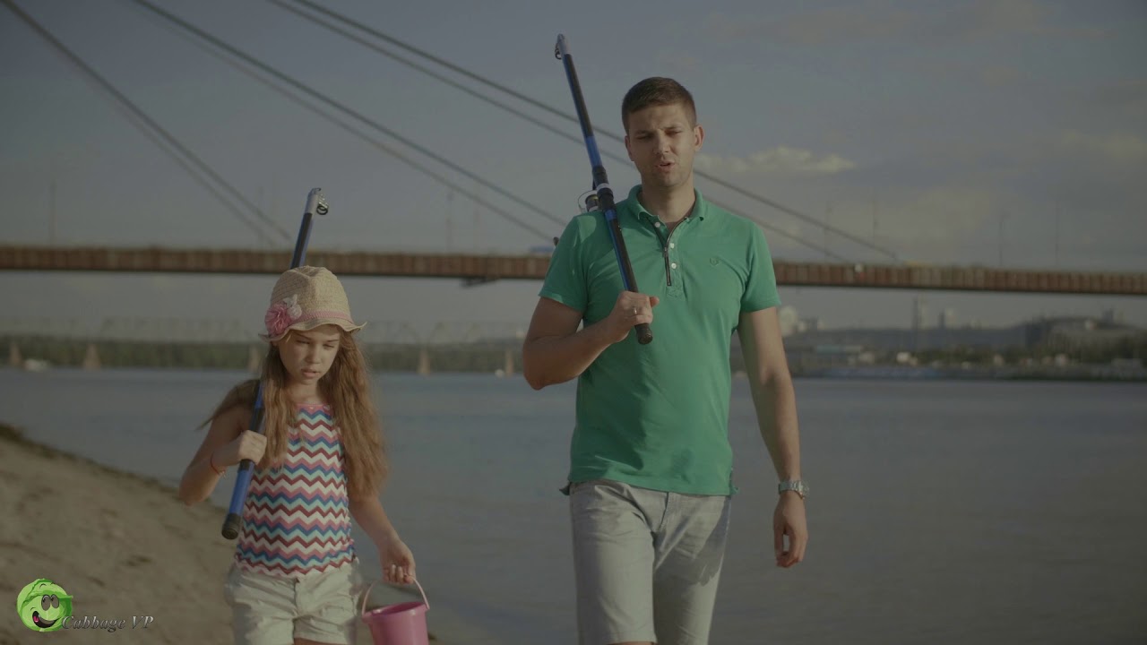 Carefree family with fishing rods walking in water