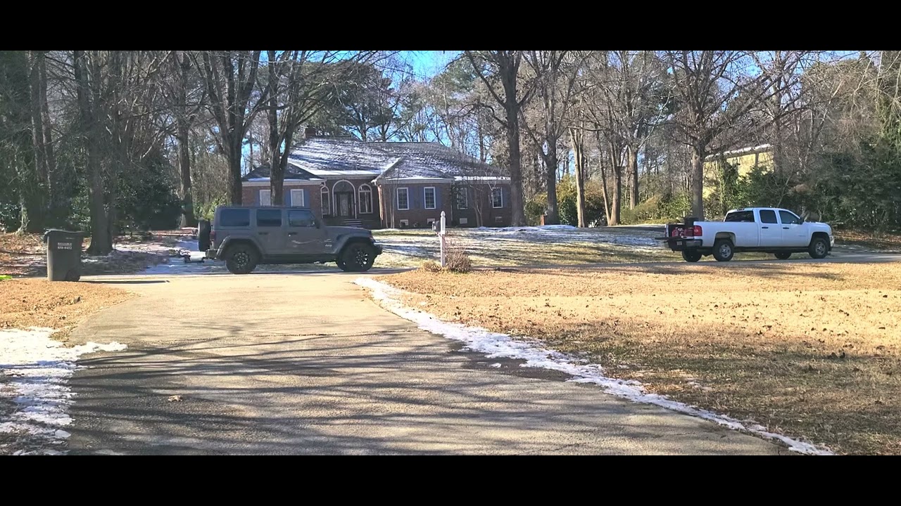 Landscapers blowing off snow from the road.
