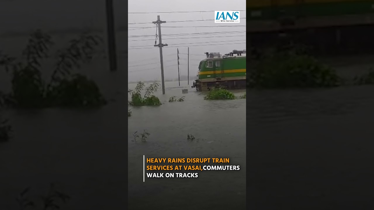Heavy Rains Disrupt Train Services at Vasai, Commuters Walk on Tracks
