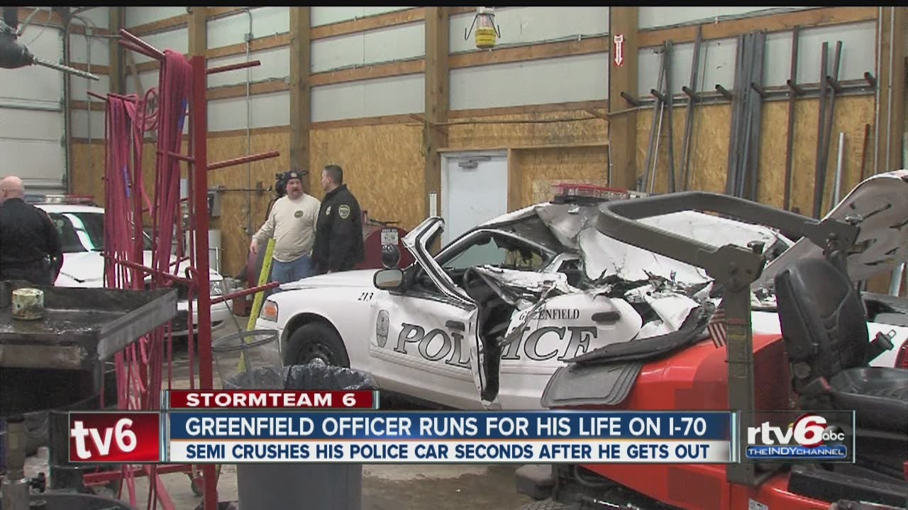 Greenfield officer runs for his life as semi crushes car