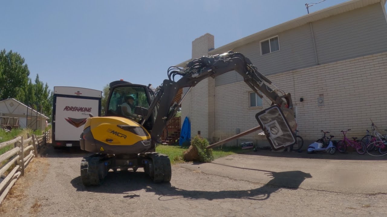 Mecalac 6MCR (exposing a septic tank lid, removing basketball goal)