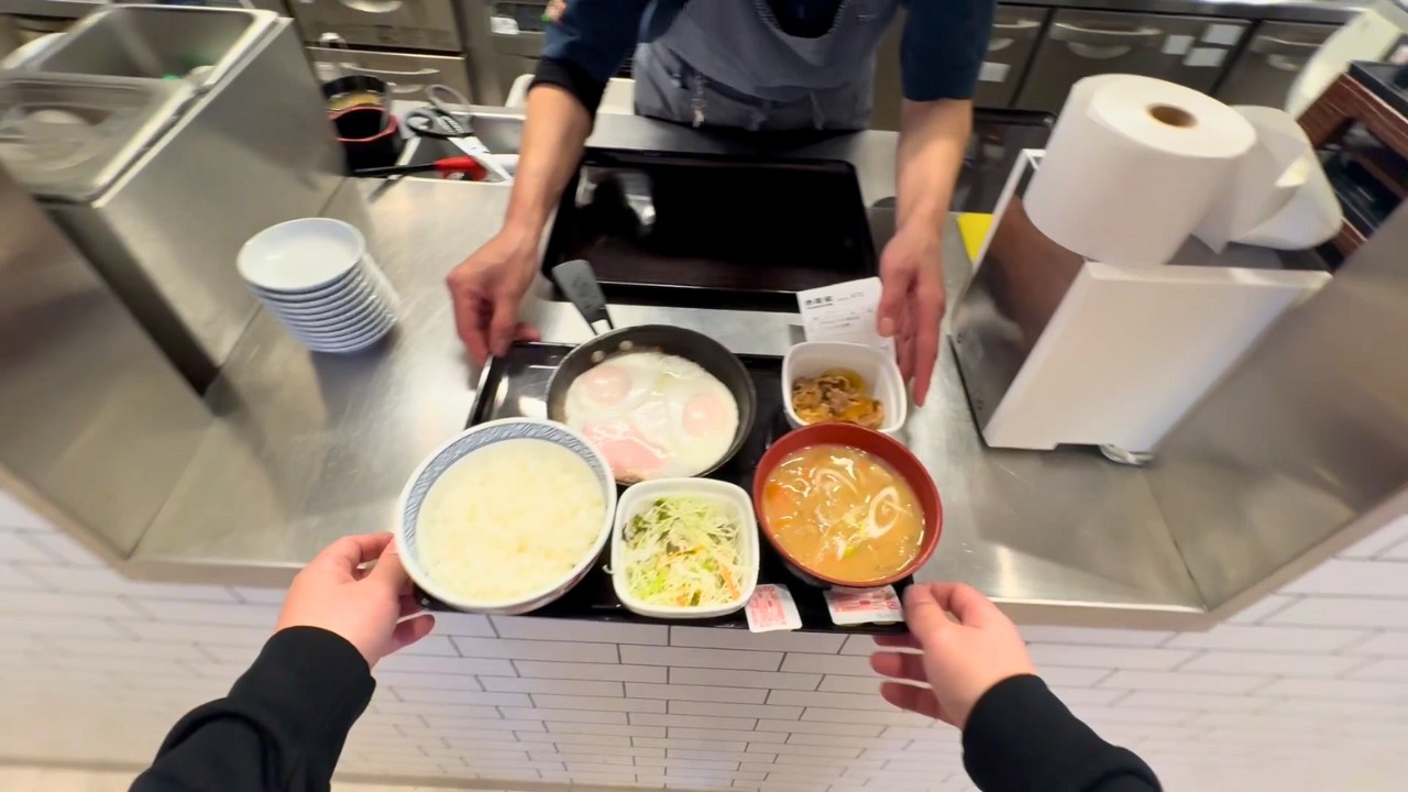 A Japanese nurse eating a ham and egg set meal at Yoshinoya for breakfast after a night shift