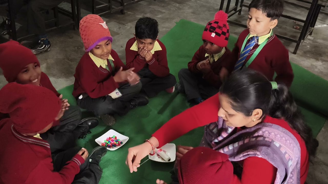 Activity:- making a thred garland with plastic beads 