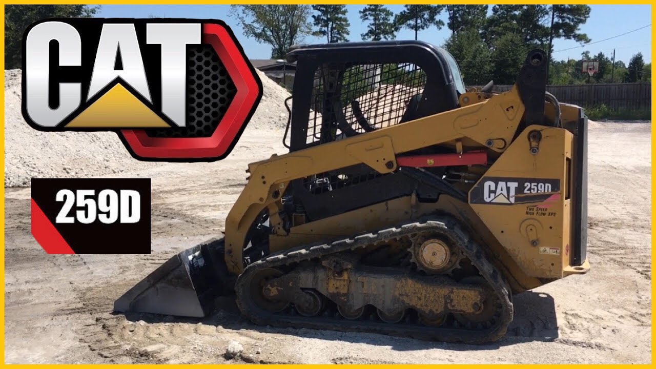 CAT 259D skidsteer pushing gravel