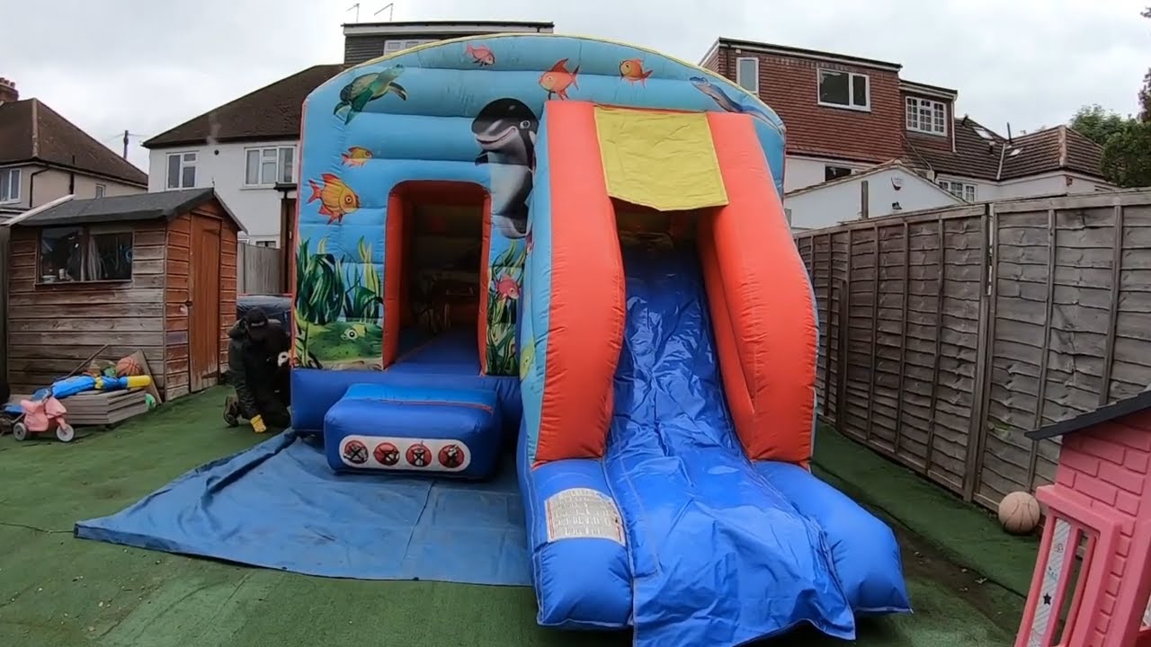 Setting Up A Bouncy Castle With Slide On ARTIFICIAL GRASS - Bouncy castle videos