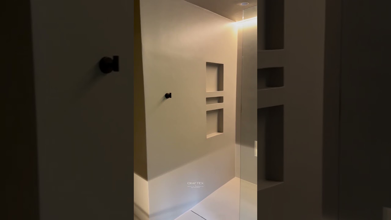 Sleek microcement shower with minimalist modern design. #microcement