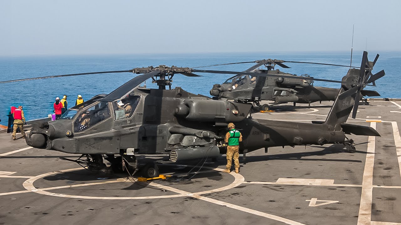 US AH-64 Apache Helicopters Land on a Navy Amphibious Transport Dock Ship