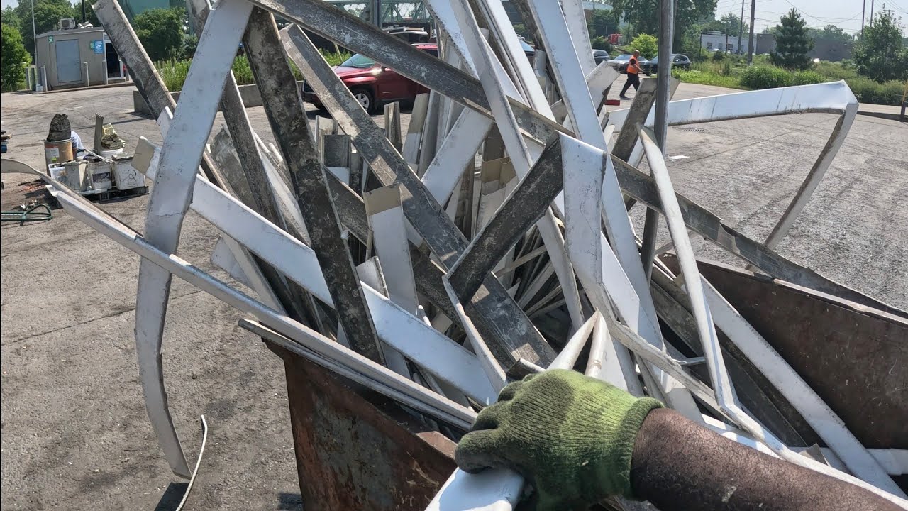 Dumpster diving in Montreal picking up aluminum siding