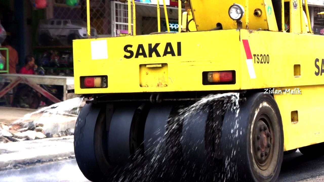 Tire roller process for compacting and leveling asphalt by SAKAI TS200