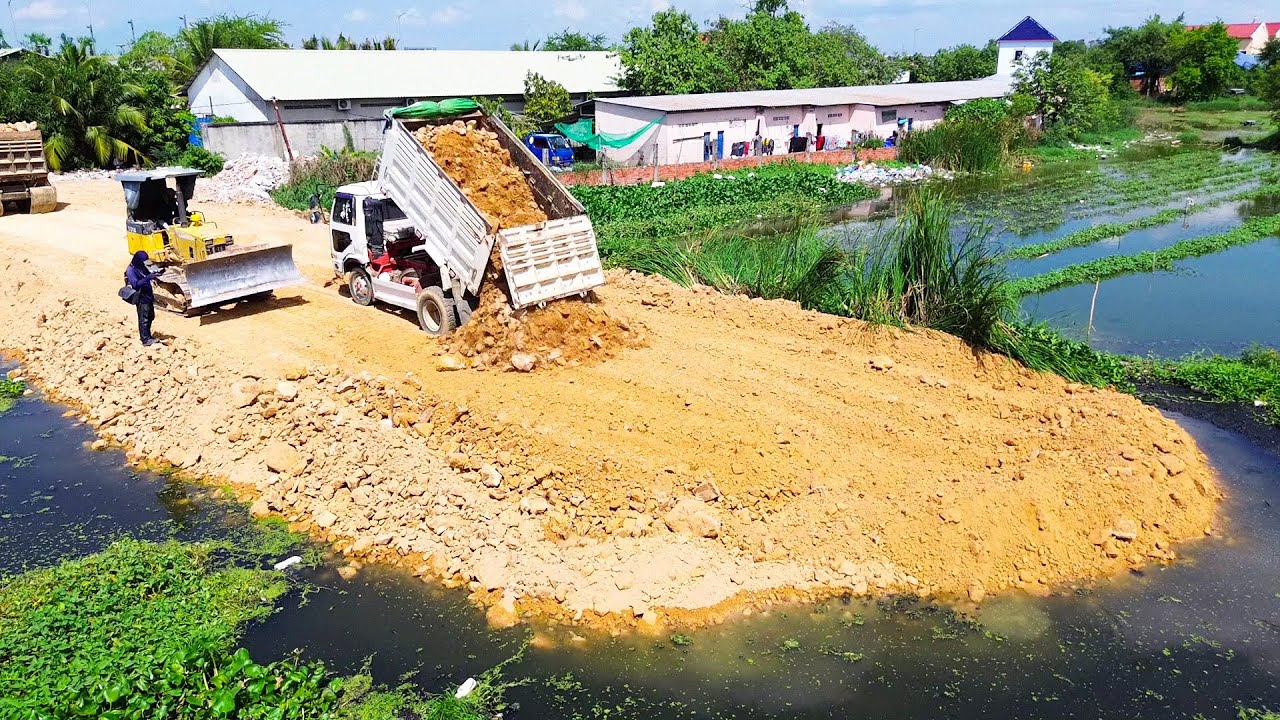 Perfect Skill Komatsu D31P Bulldozer Pushing Soil to Build Road in Swamp