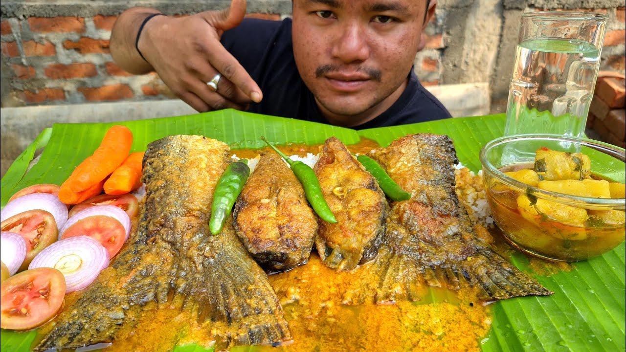 EATING  PANGASIUS FISH CURRY AND RICE 