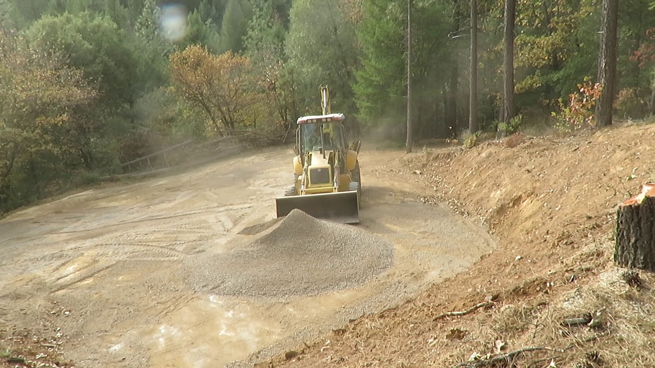 Spreading road base on Gilman property