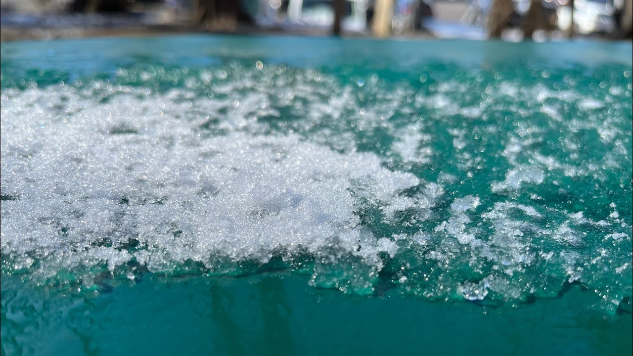 Snow melting on a picnic bench in real time