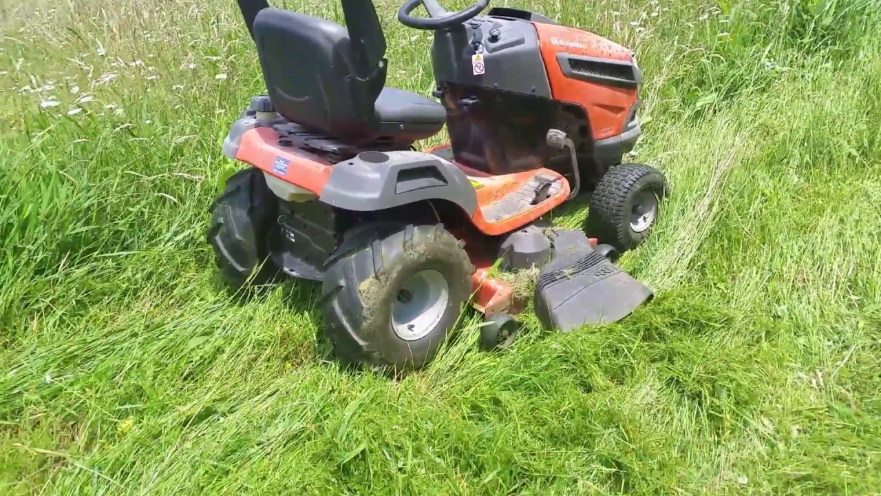 Husqvarna YTA24V48 One year later review.  Mowing tall, wet grass with ATV tires.