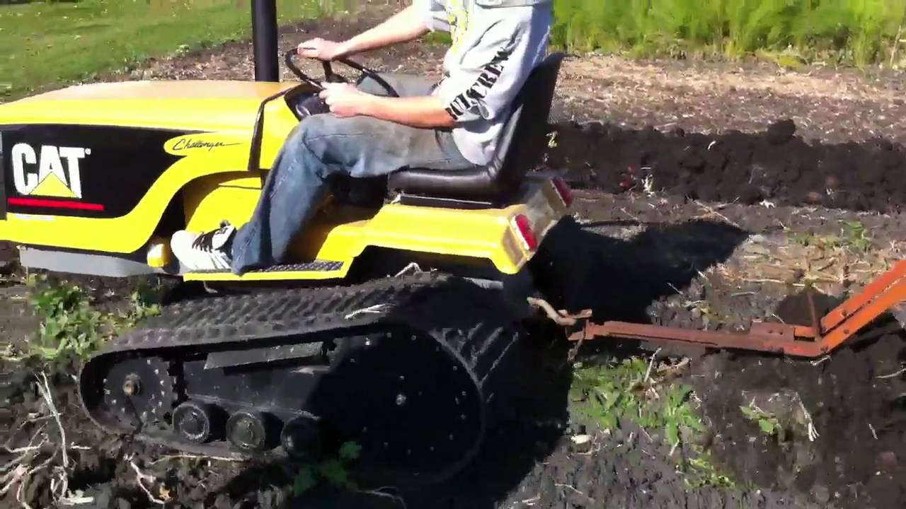 Mini Cat Challenger plowing potatoes