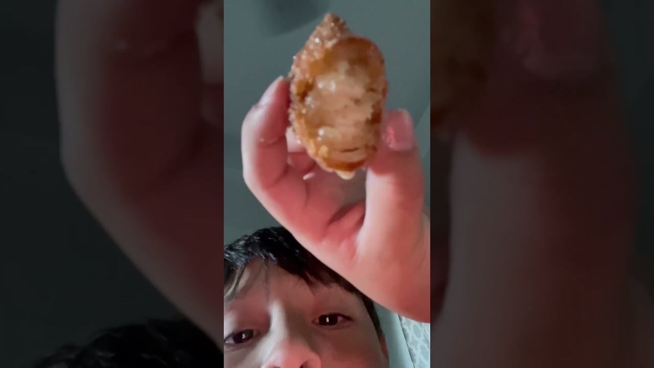 Trying Chinese donut hole dipped into icing