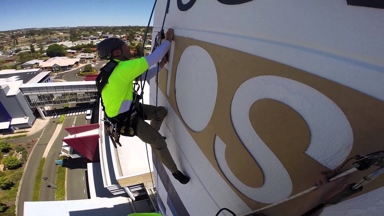 How to install a sign on the side of a building using rope access.