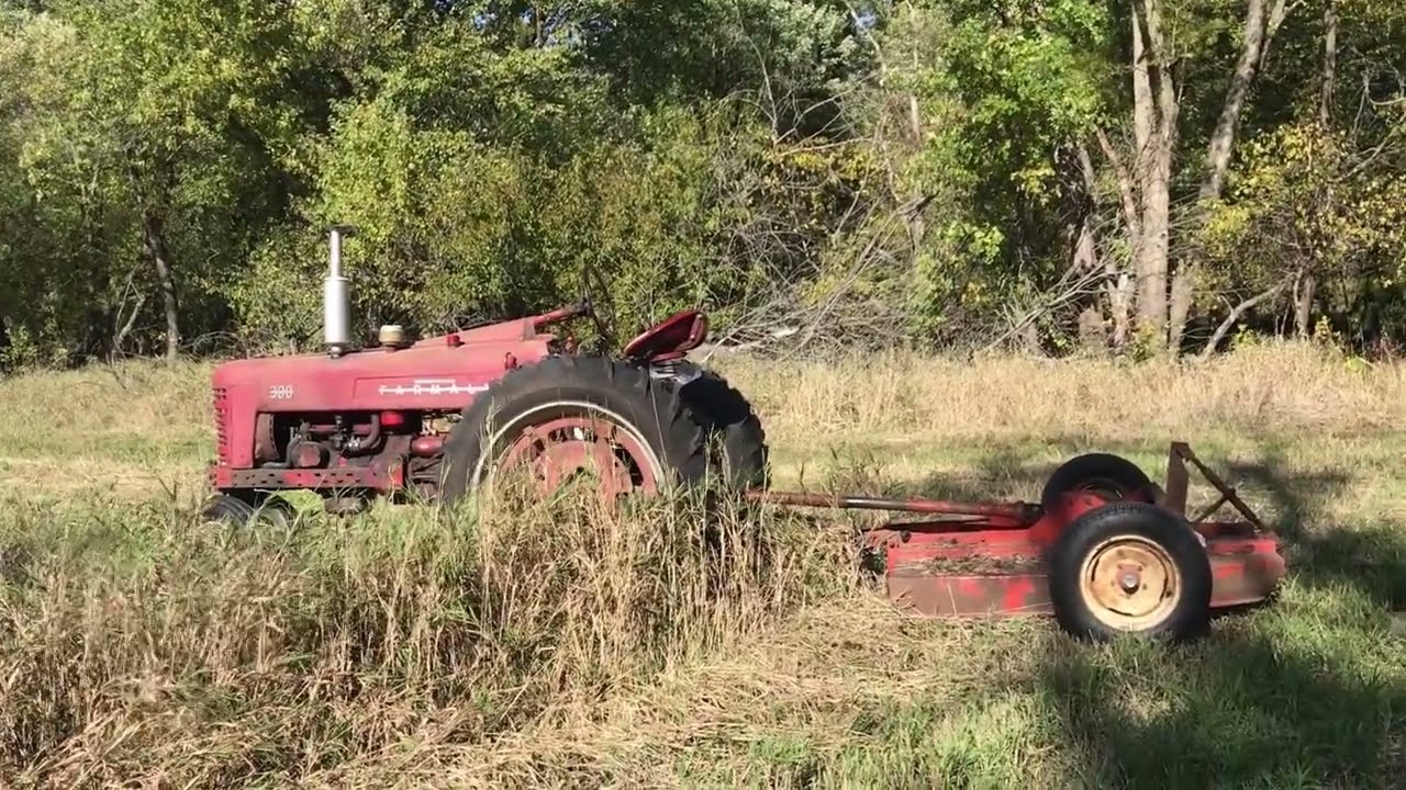 IH Farmall 300 pulling a bushog
