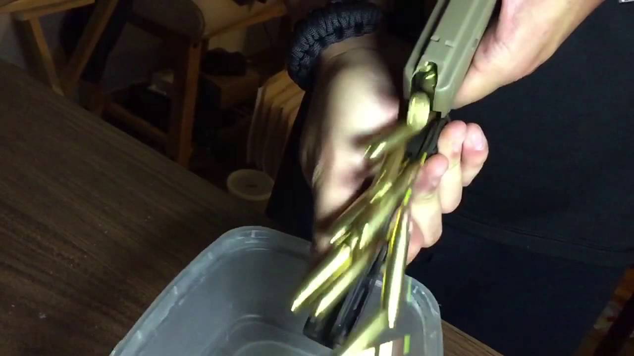 Unloading a full AR magazine in under a second using a StripLula