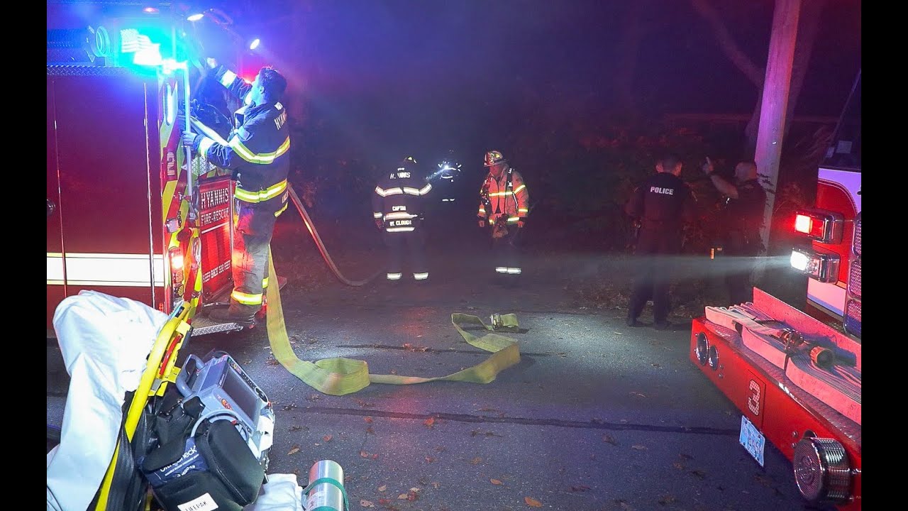 FIREFIGHTERS CONTEND WITH OVERGROWN VEGETATION TO BATTLE SMOKY FIRE INSIDE UNOCCUPIED HOUSE