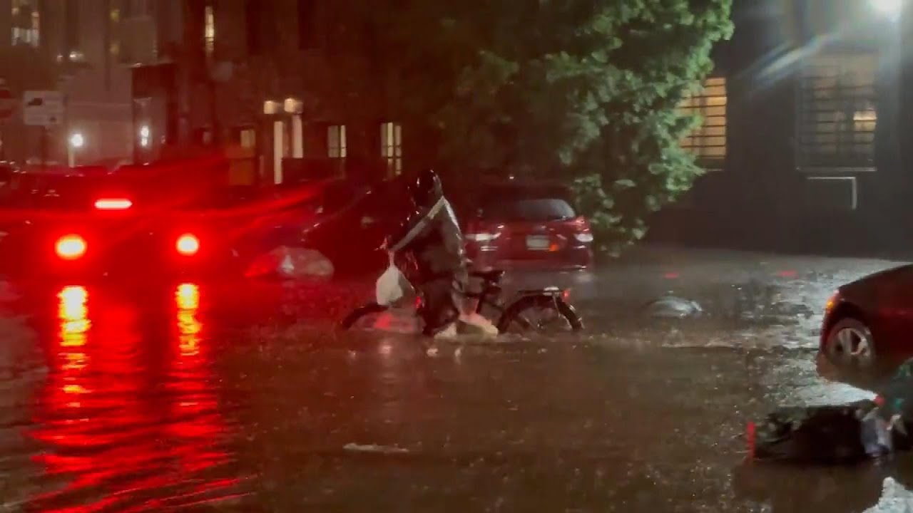 Delivery Man Pushing Bike Through Flood Waters Sparks Outrage