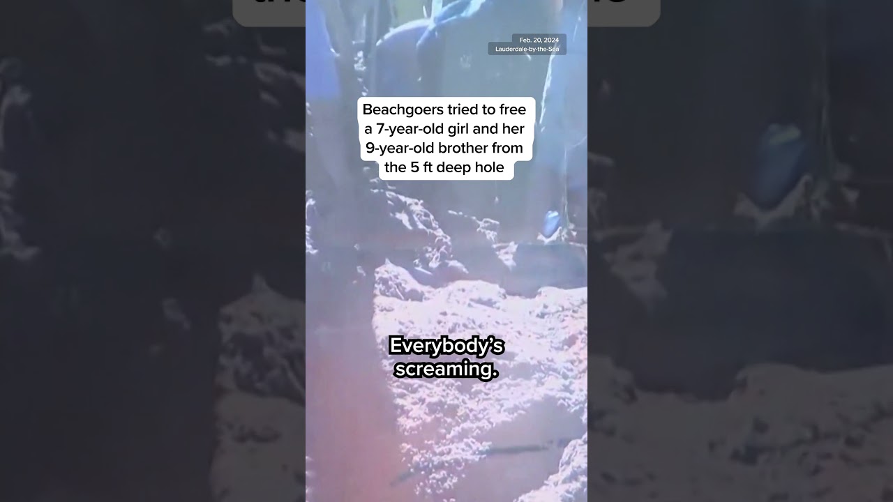 Two kids trapped in sand hole while playing on the beach