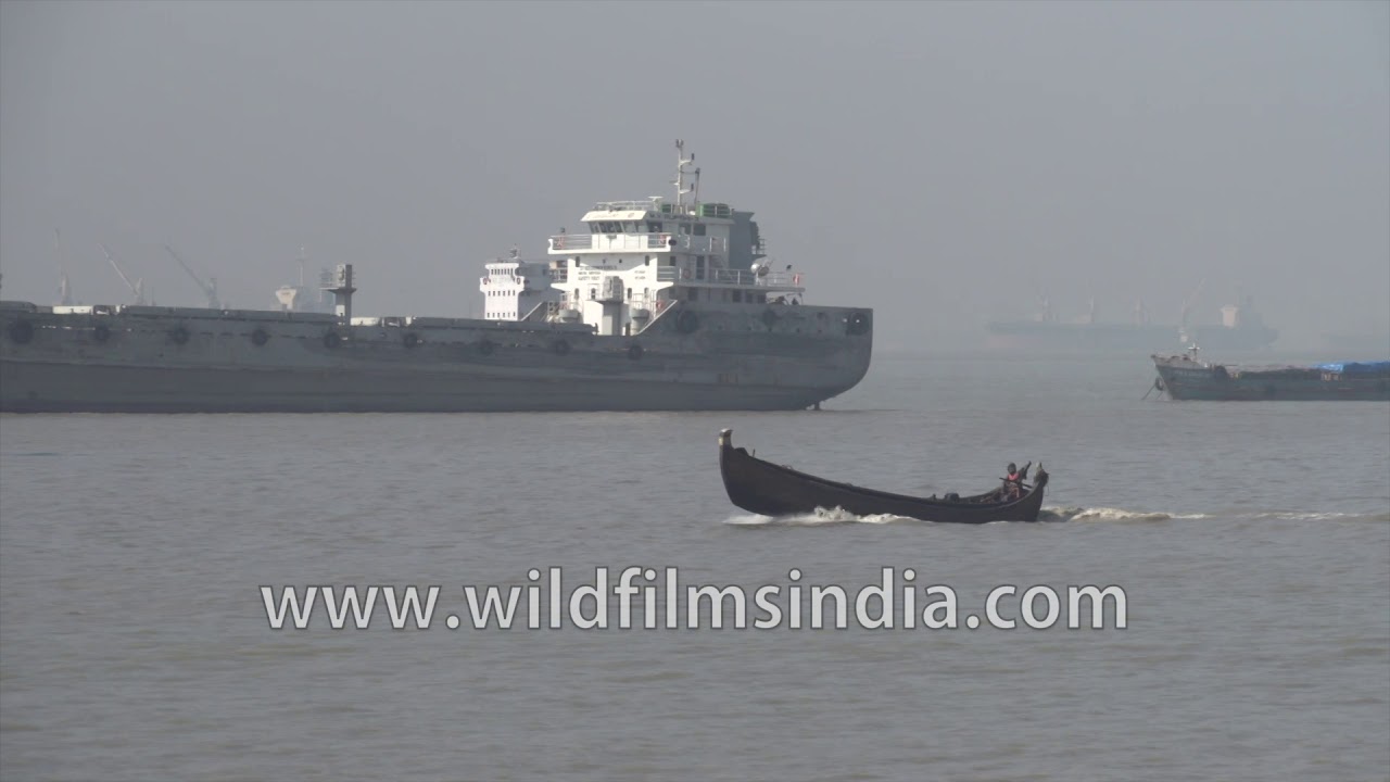 Ships, boats and street vendors at Patenga Sea Beach in Chittagong, Bangladesh